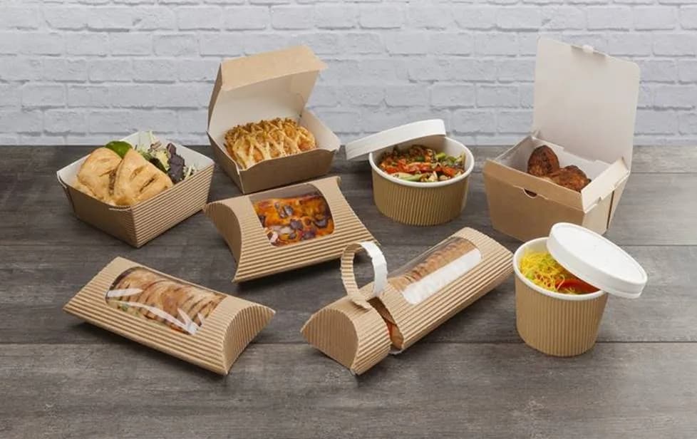Assorted paper takeout containers and food packaging on a table